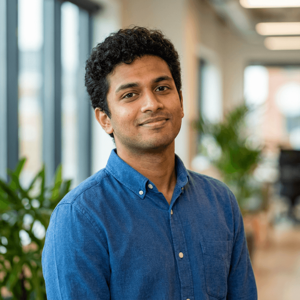Male cybersecurity consultant in his early 30s smiling in a modern office